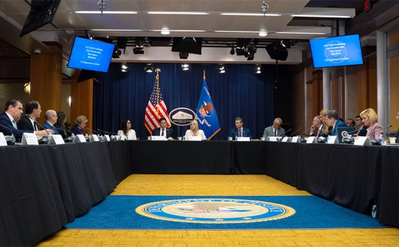 Attorney General Pamela Bondi delivers remarks from the center of a roundtable meeting at the Department of Justice. She is joined by Department of Justice and federal government officials.